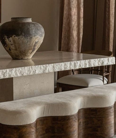 Stone console and curved bouclé bench